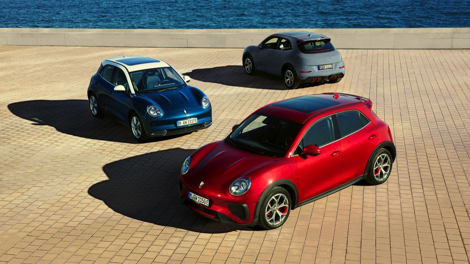 3 GWM Ora electric cars lined up, red, blue and grey