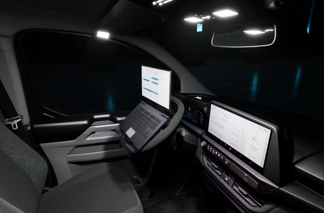 Ford e-transit custom interior shot of front cab using laptop stand.