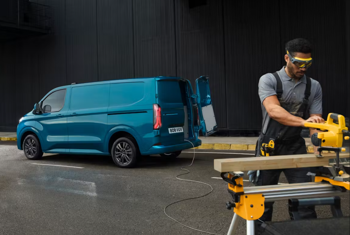 Ford e-transit custom with worker and tools plugged in using Vehicle to load tech