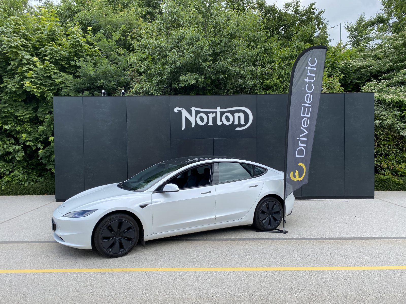 Tesla at salary sacrifice scheme launch event, branded driveelectric flags at Norton motorcycles HQ