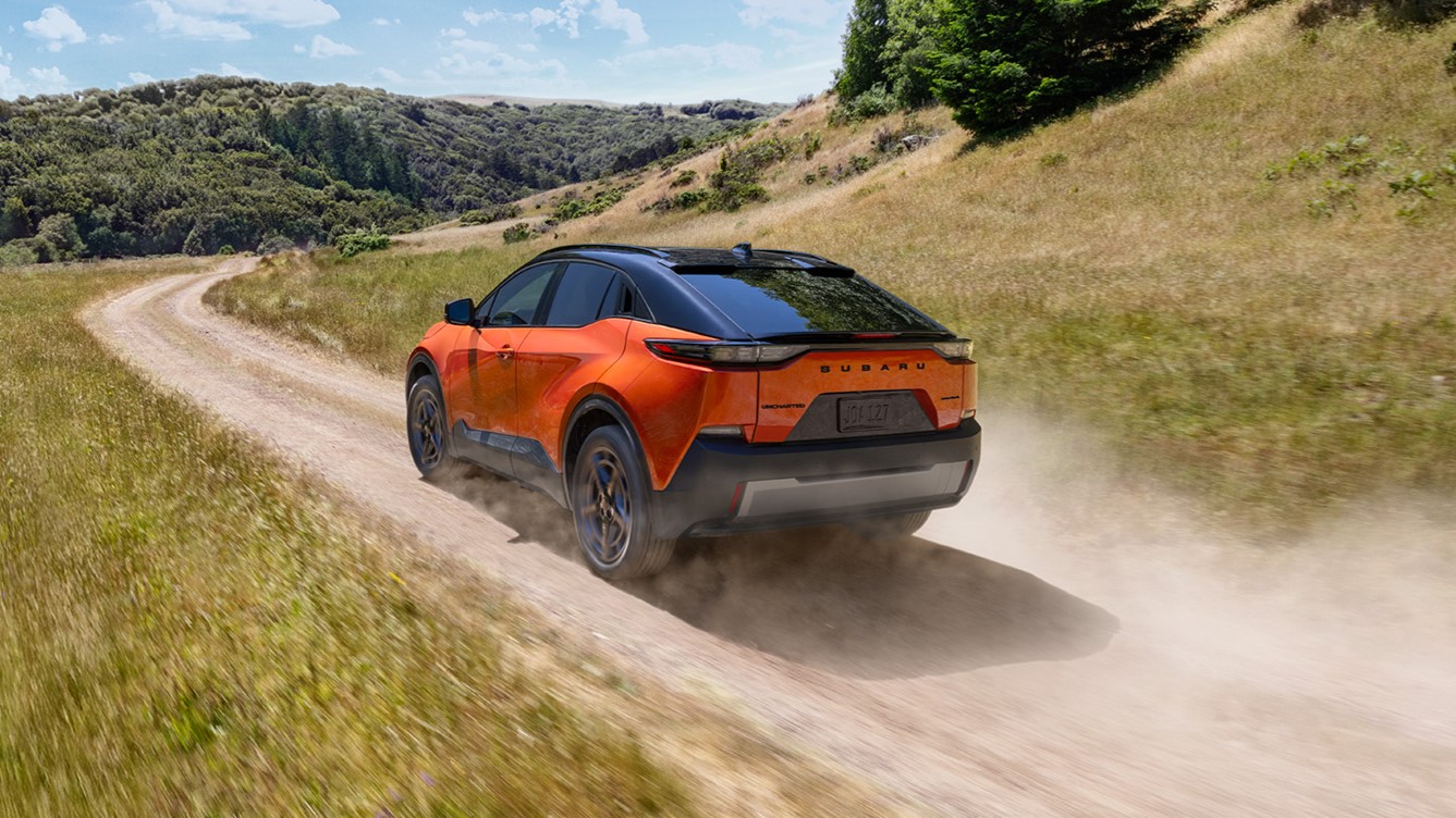Subaru uncharted electric car in orange driving on an offroad track
