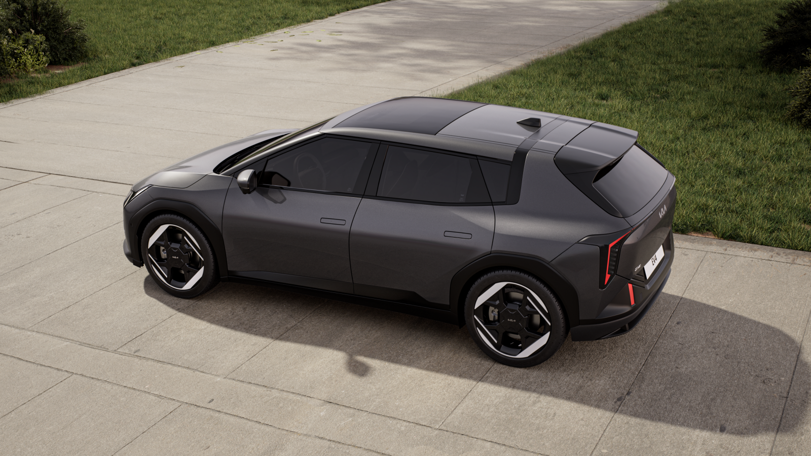 Kia EV4 electric car on driveway with grass in background