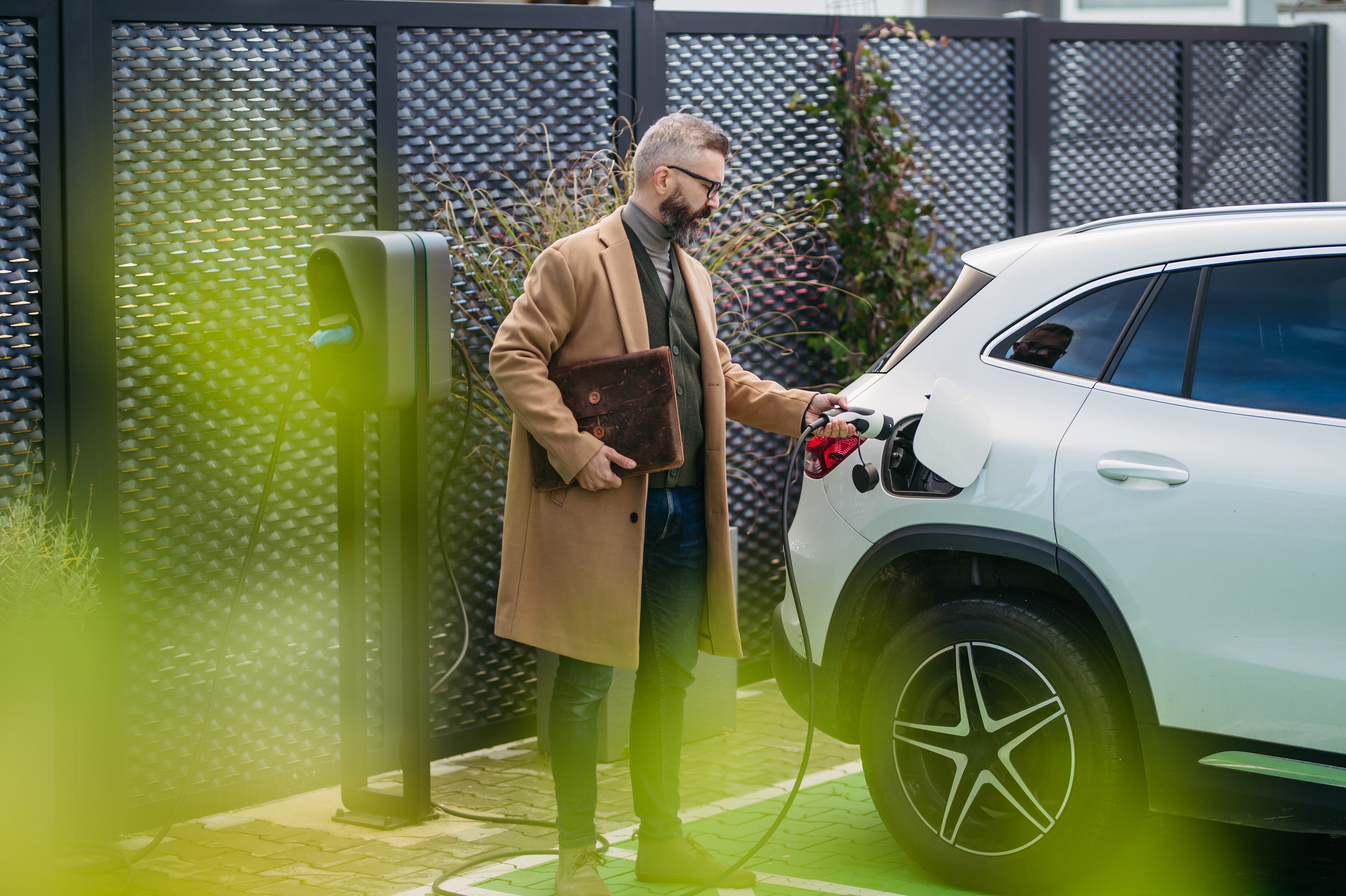 Man plugging a car into charge