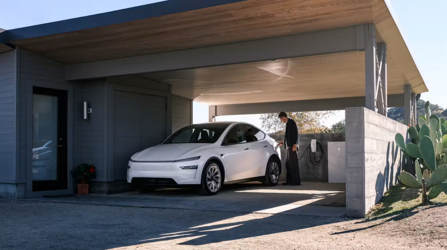 Tesla model Y electric car in white, charging in garage